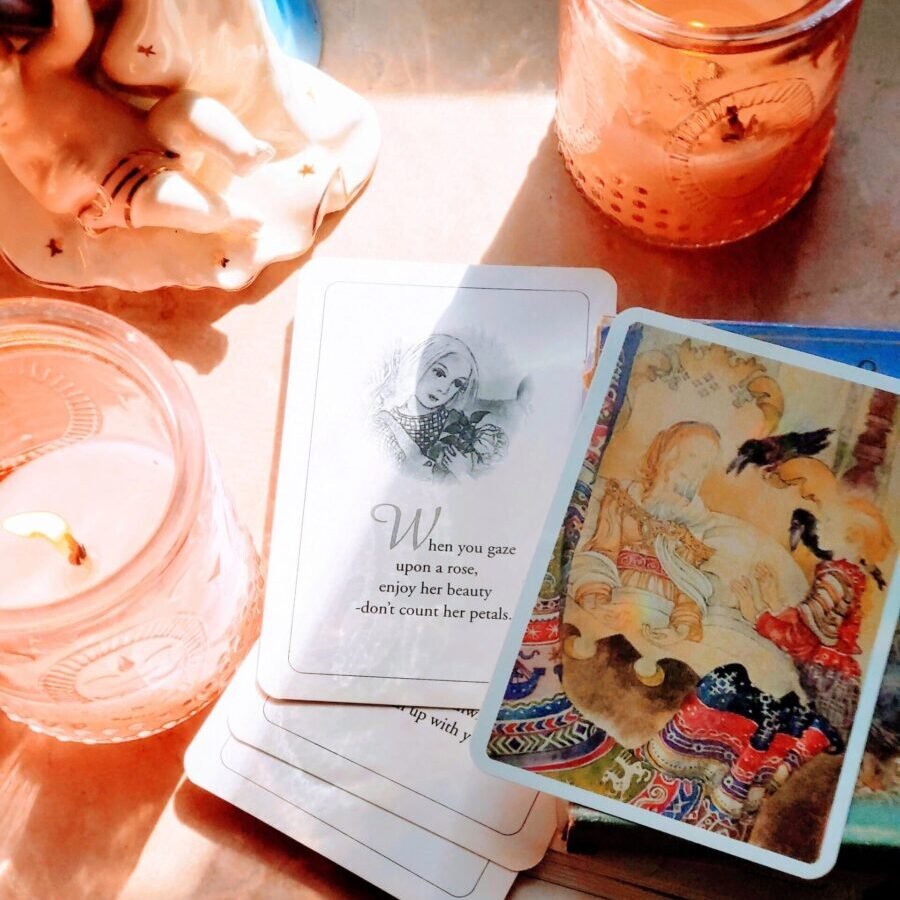From above bright cards with colorful paintings and wise inspiring aphorisms heaped on tables among cozy candle holders and souvenirs in sunlight